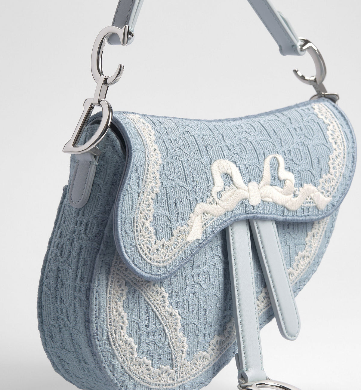 Small Saddle Luxury Handbag With Céleste Blue Oblique Embroidery And White Lace And Strap