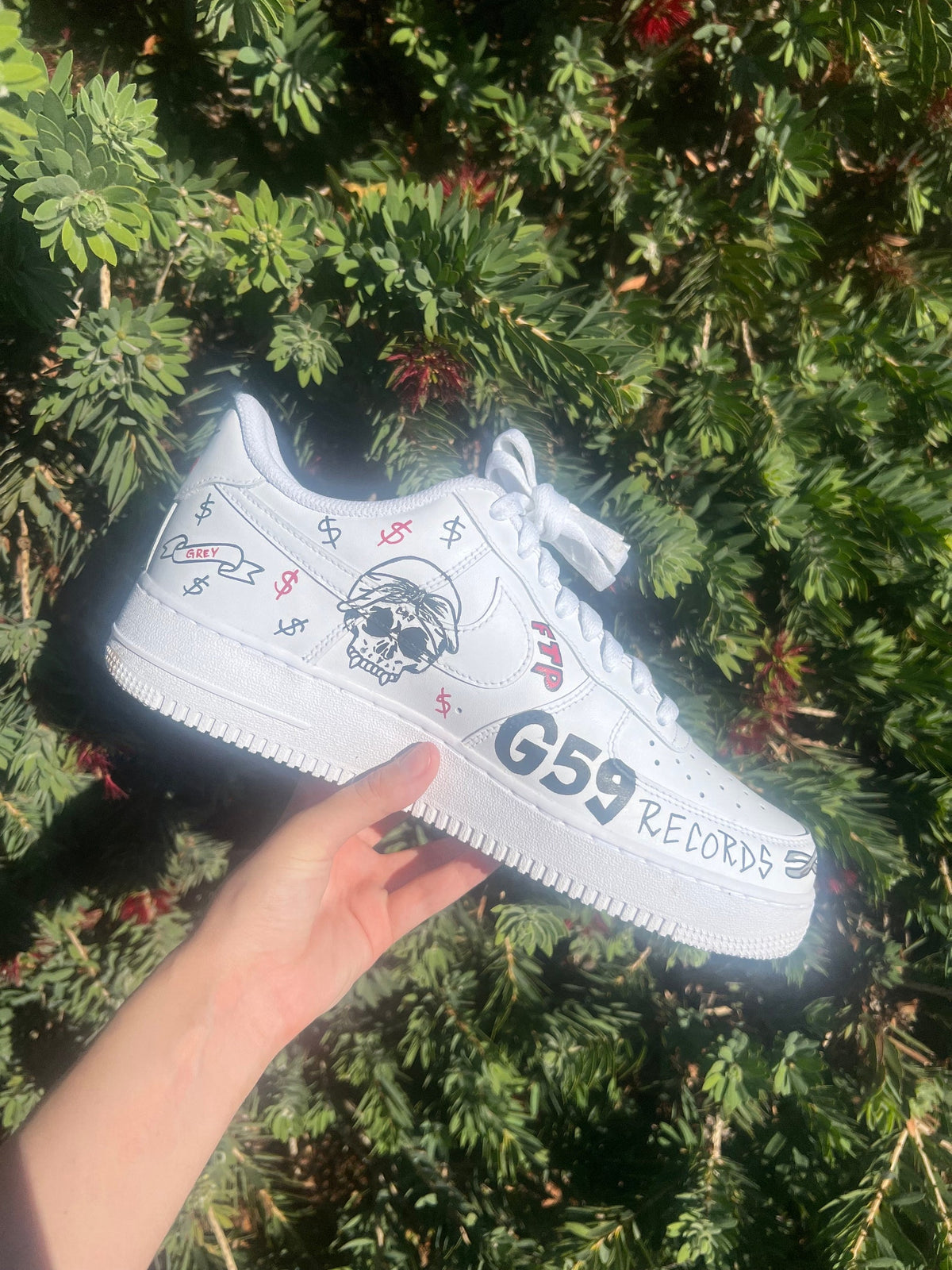 Custom Air Force 1s black and red artist themed