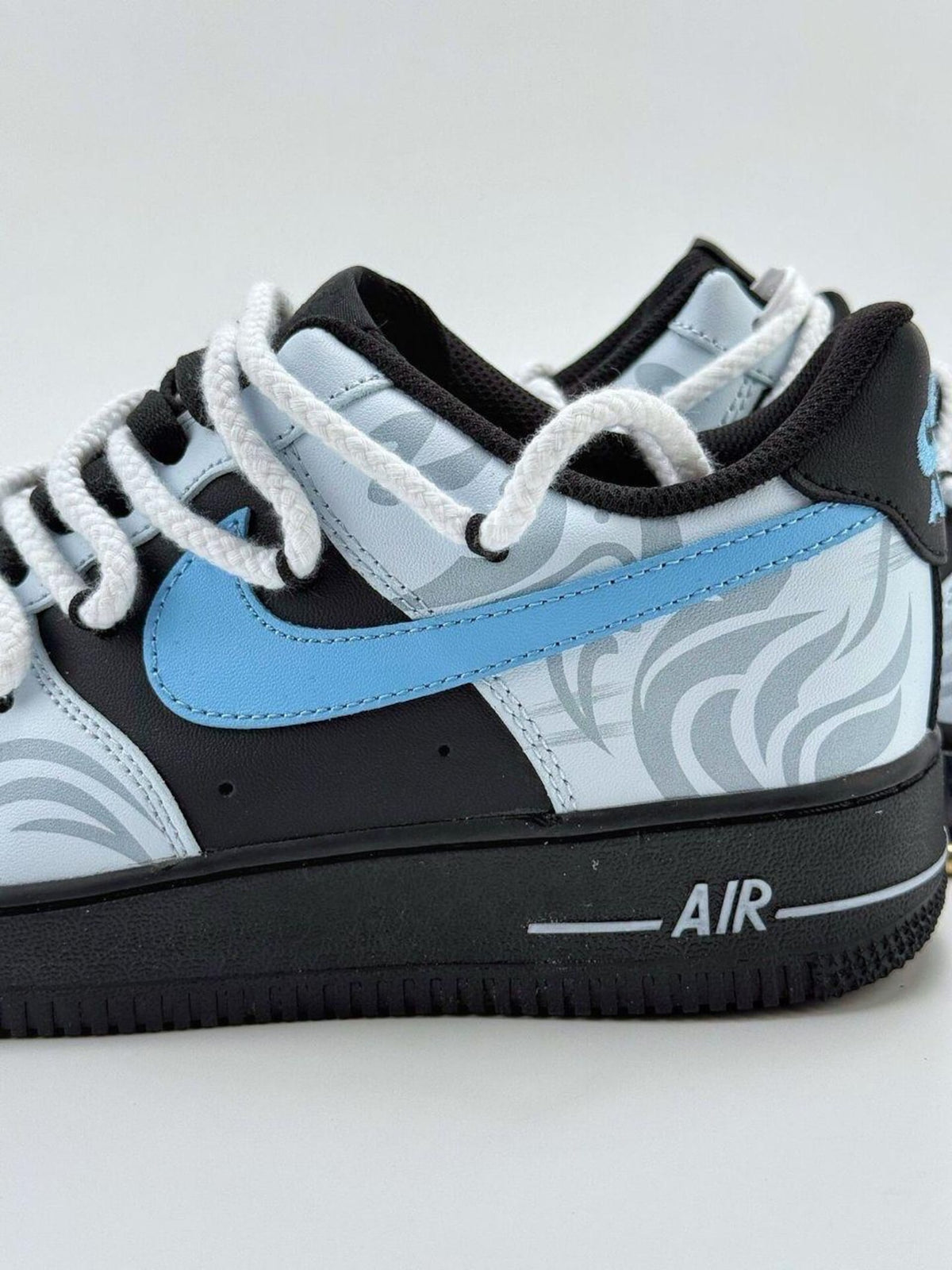Custom handcrafted black and blue Air Force 1 sneakers